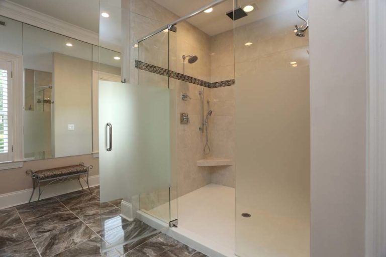 Master bathroom with large walk-in shower and marble floor tiles.