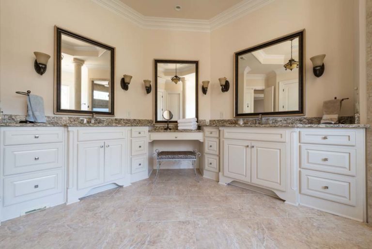 Bathroom with two sinks, vanity, and three mirrors.