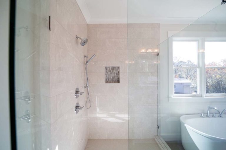 Bathroom with large tiled shower and stand-alone tub