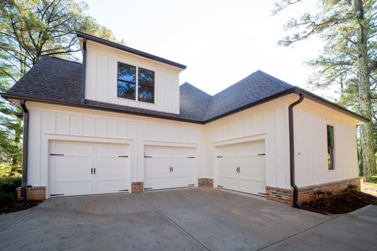 Three-car garage with traditional style doors